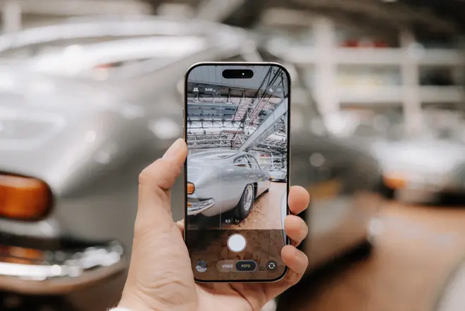 A car is photographed with a smartphone.