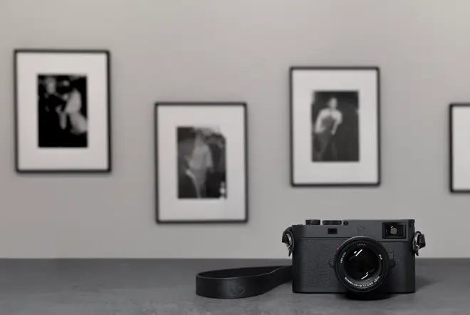 Leica M11 in front of framed photographs
