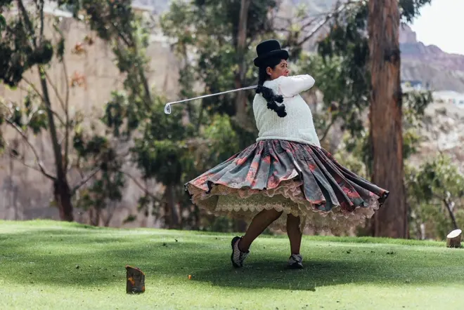 Bolivian woman golfing.