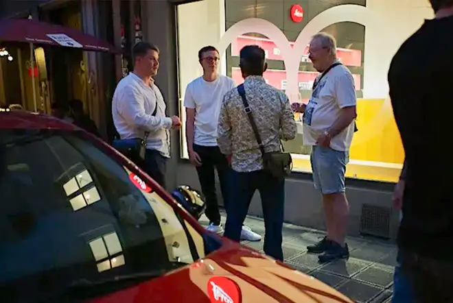 Group of people in front of a Leica Store
