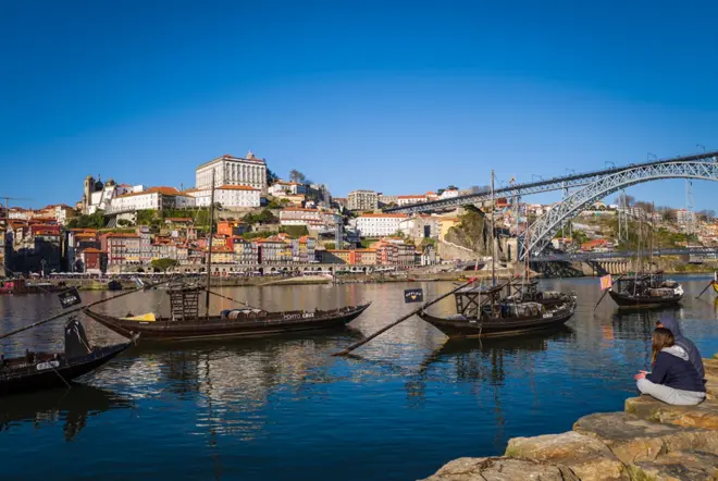 People are sitting by the water in Porto