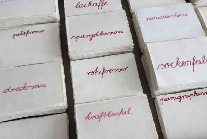 Stacks of paper from the past, lying side by side and printed in red.