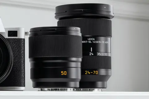 Summicron-SL 50, Vario-Elmarit-SL 24-70 in group standing on white background, with SL2 silver in bleed