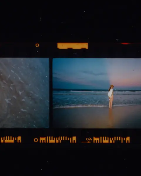 Photographed filmstrip with different images of water and a woman at the sea
