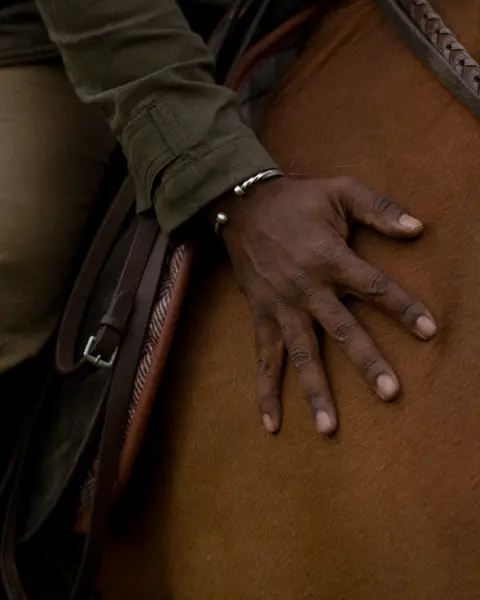 Close-up of a person sitting on a horse