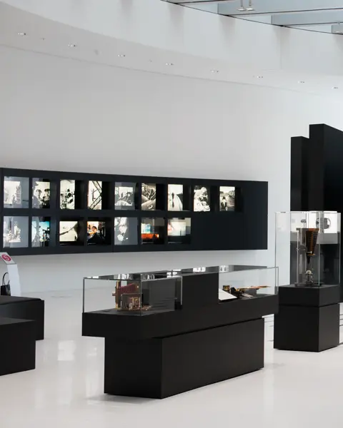 Exhibition hall with displays of historic cameras and photographs.