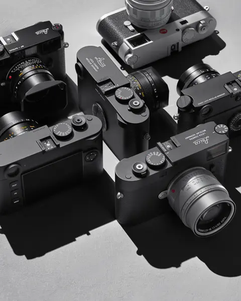 Top view of several Leica cameras on a gray background