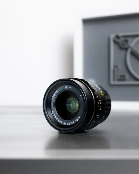 Leica camera with a lens on a table.