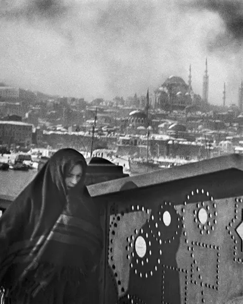 Woman crossing a bridge