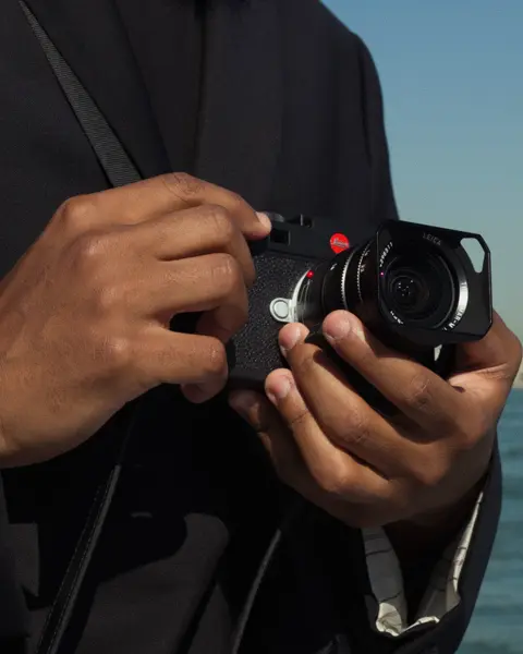 Male hands holding a Leica M