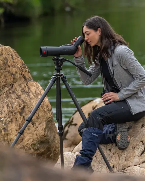Woman-is-looking-through-her-Leica-Spotting-Scope