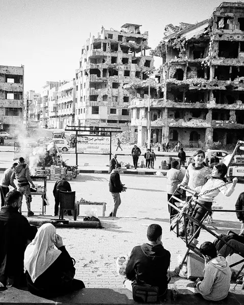 Syria after the fall of the regime in 2024. Many people in front of old ruins