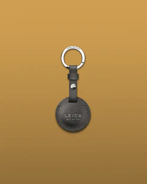 Black airtag holder from Leica on keyring.