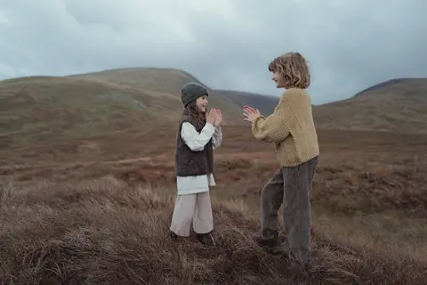 two kids in the fields of scotland