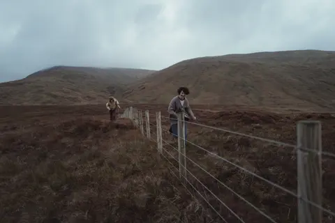 two kids in the fields of scotland