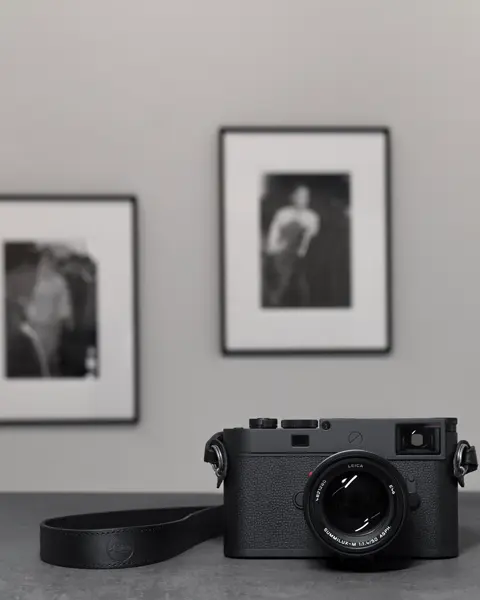 Leica M11 in front of framed photographs
