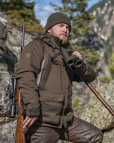 Hunter with his Leica Geovid Pro in olive green