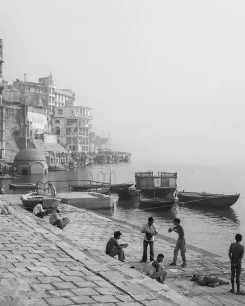 Black-and-white photo of people at a harbour in India