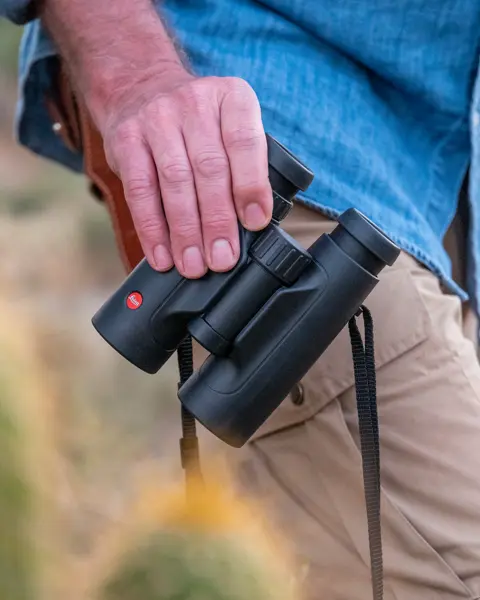Man holding a Leica Trinovid HD