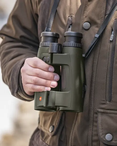 Hunter with his Leica Geovid Pro in olive green
