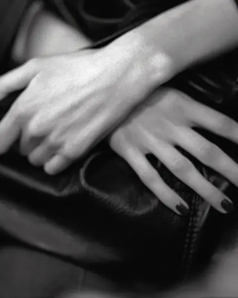 Her hands folded in her lap