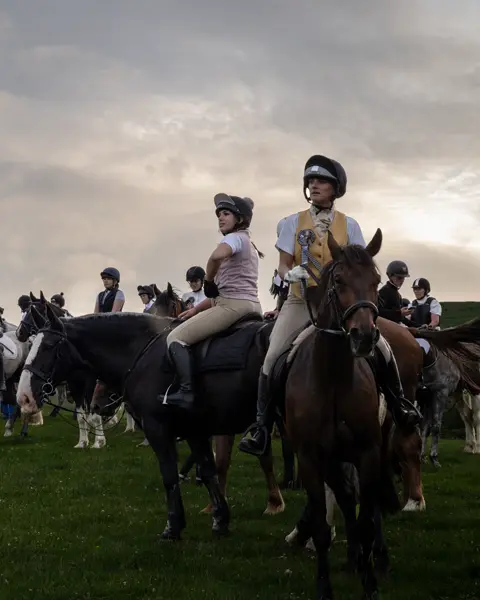 AA lot of riders on a meadow