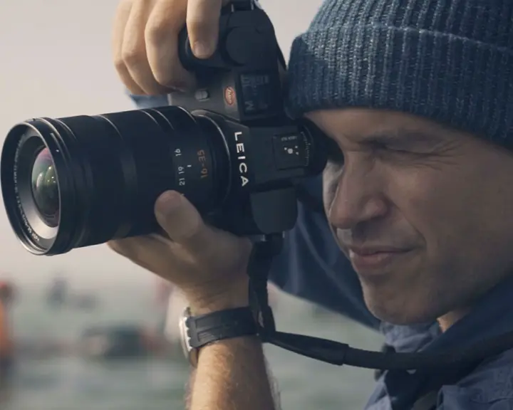Close-up of a man taking a picture.