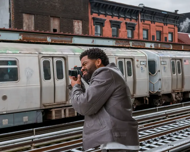 Man photographs a train with a Leica M11