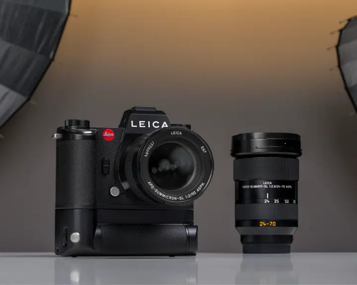 A Leica camera placed on a table in a photography studio setting
