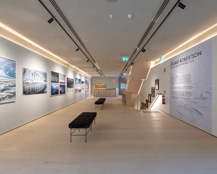 Exhibition room with photographs from Antarctica and a description of the photo project ‘Colours of Antartica’ by Stuart Robertson.