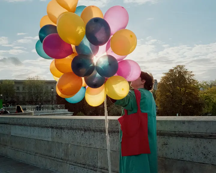 A person is holding balloons