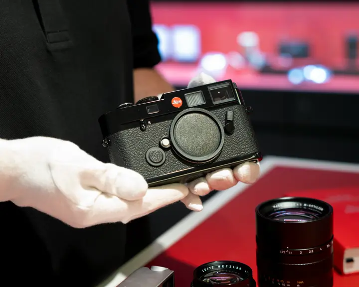 Close-up from a Pre-Owned Leica, held in gloves
