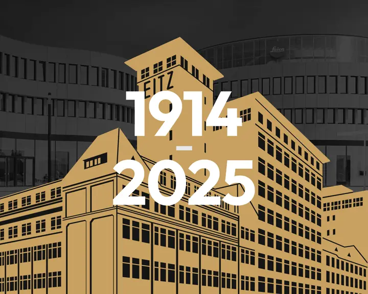 Grafik Leitz factory in front of Leica office building. Lettering 1914-2025.