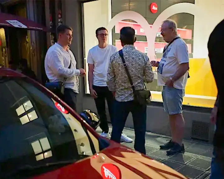 Group of people in front of a Leica Store