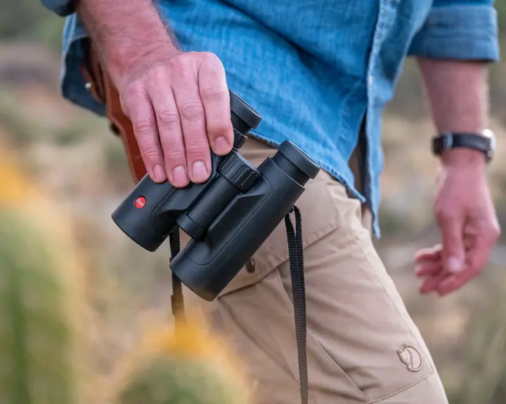 Man holding a Leica Trinovid HD