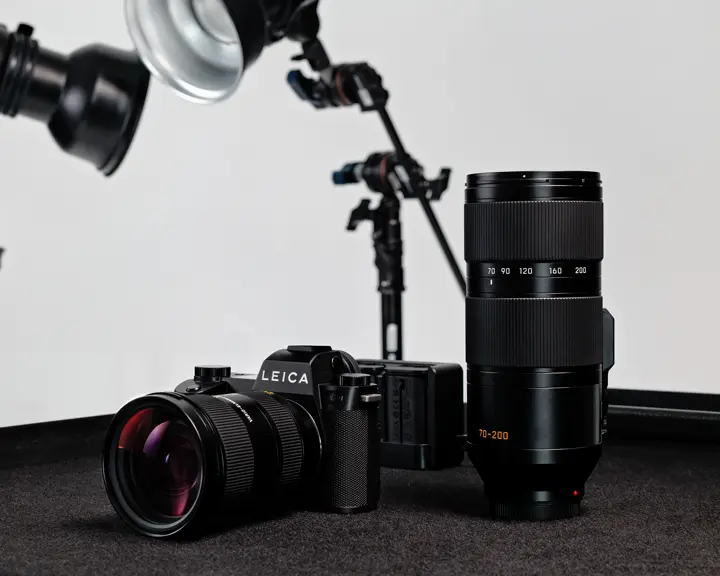 Leica SL3-P with Vario-Elmarit-SL 24-70 on a table next to the Vario-Elmarit-SL 70-200