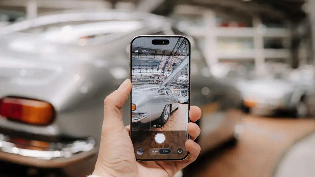 A car is photographed with a smartphone.