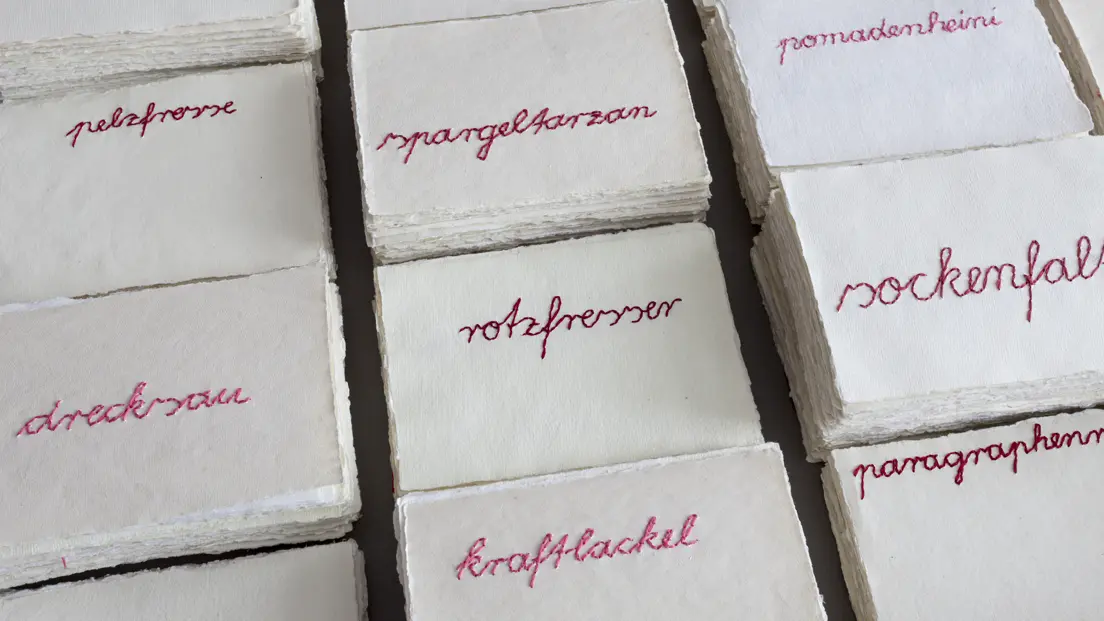 Stacks of paper from the past, lying side by side and printed in red.