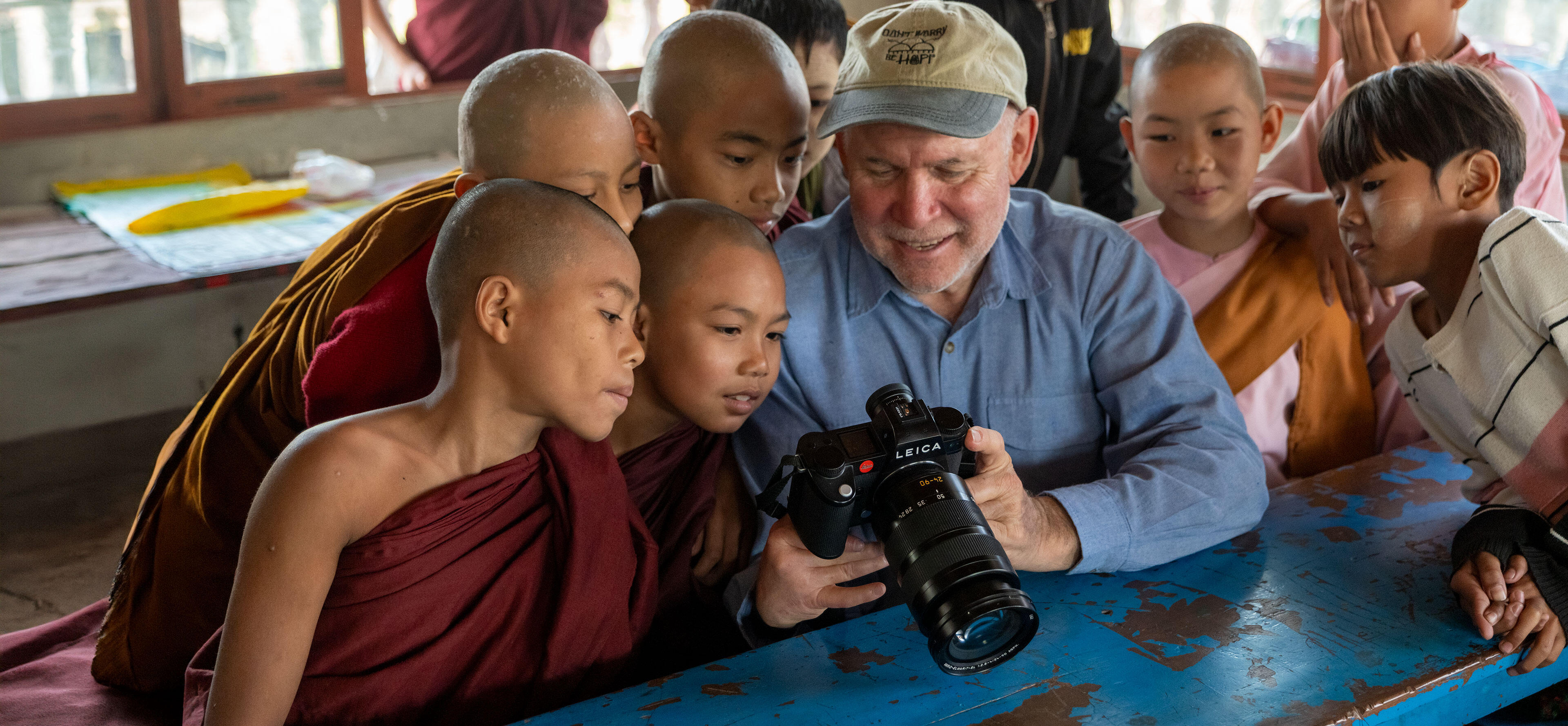 Steve Mc Curry with SL3 in hands together with children