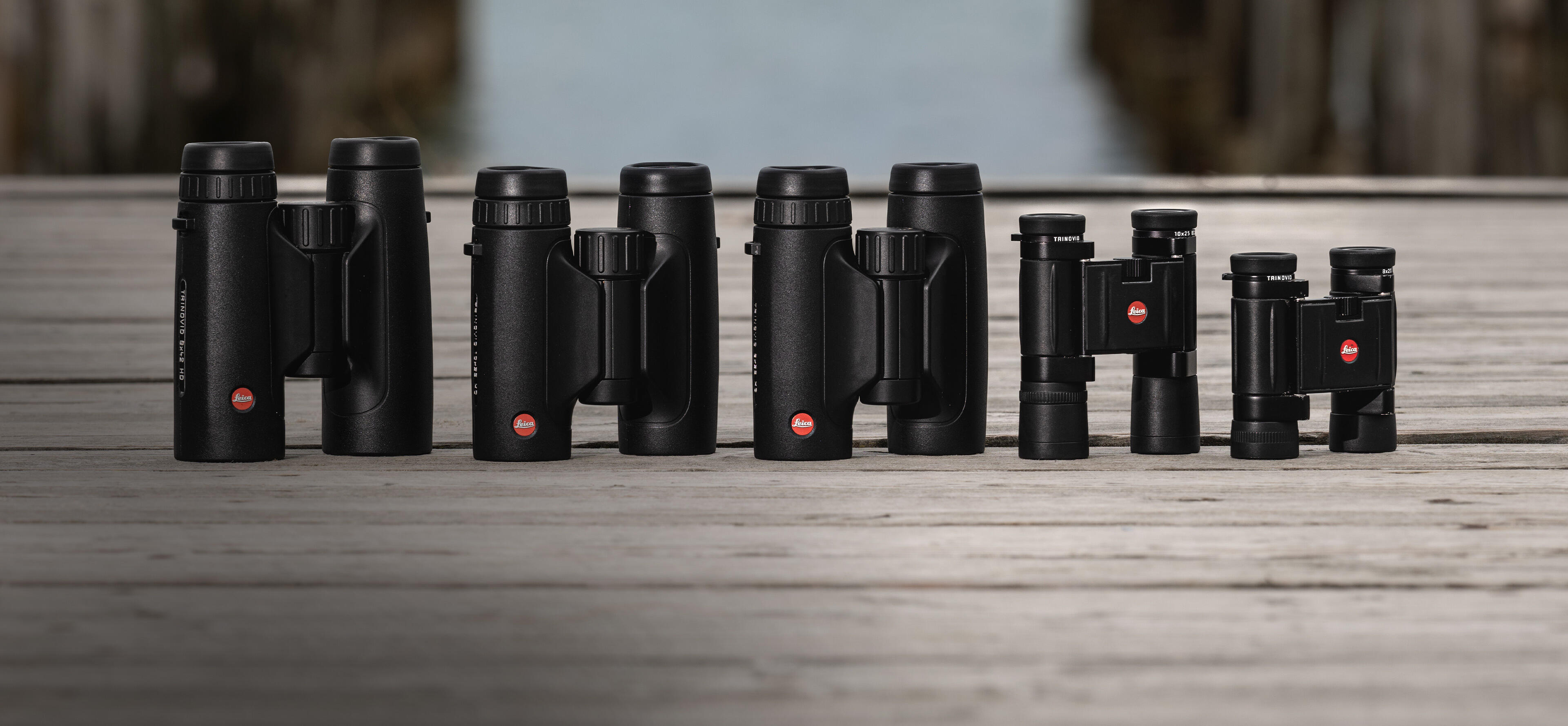 leica-trinovid-binoculars-lined-up-on-a-wooden-bridge-by-the-sea