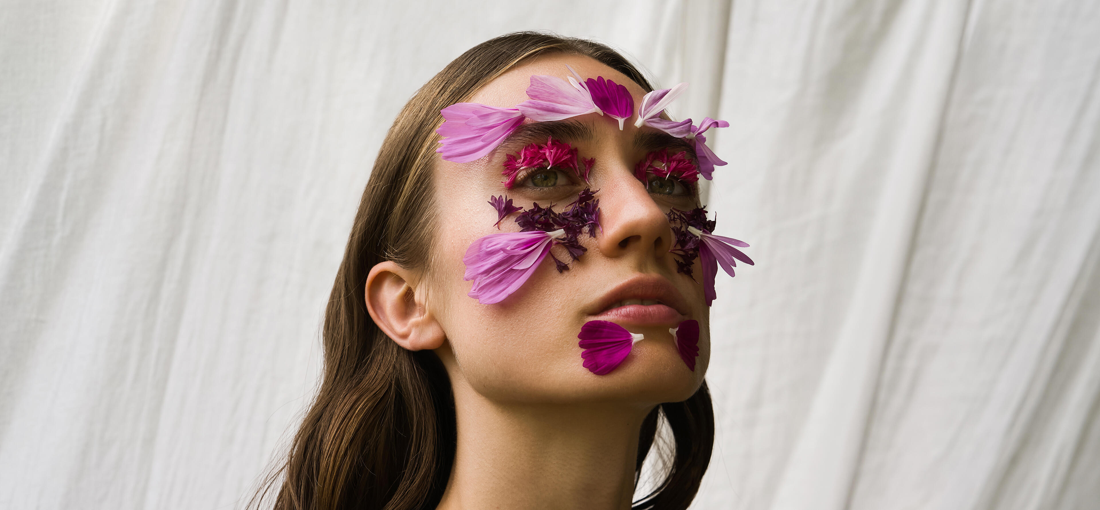 Portrait of a woman with flowers on her face skin