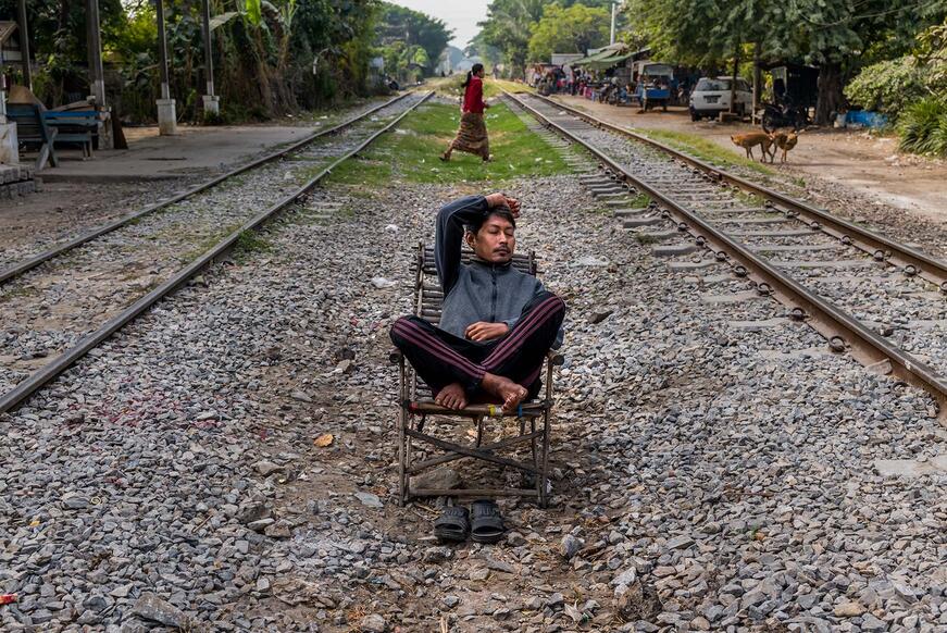 sleeping man between railroad tracks