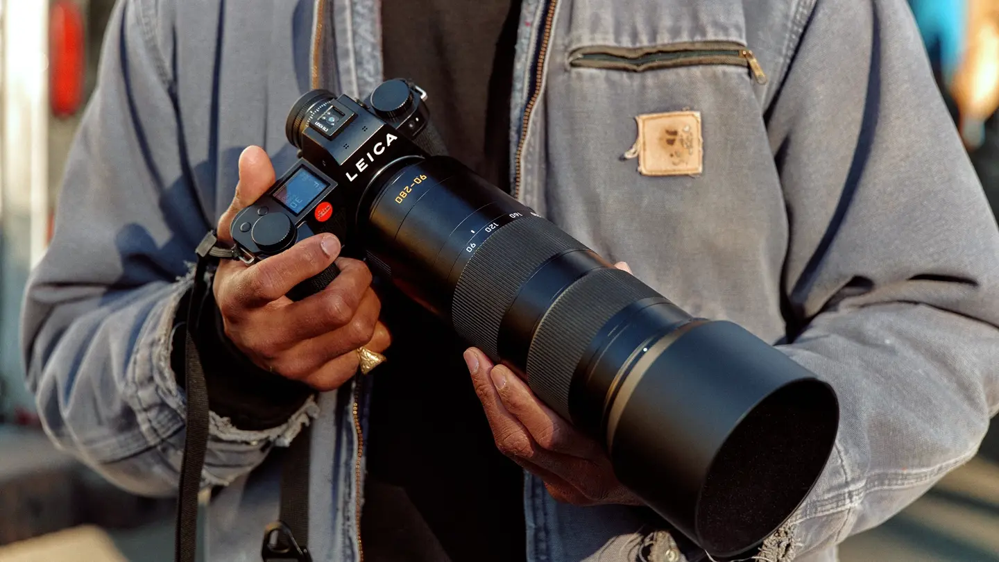 A man holding a Leica camera in his hand