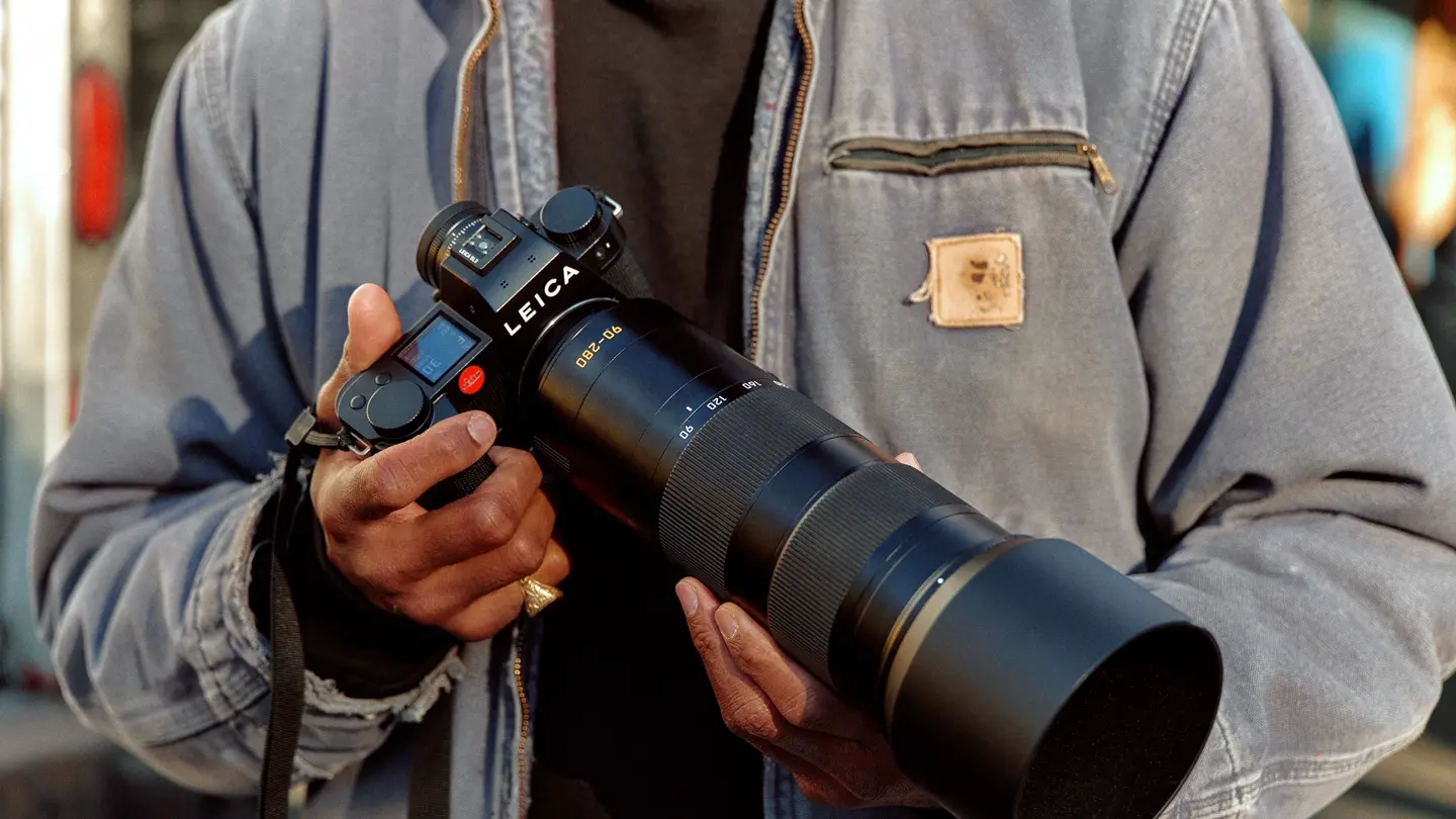 A man holding a Leica camera in his hand