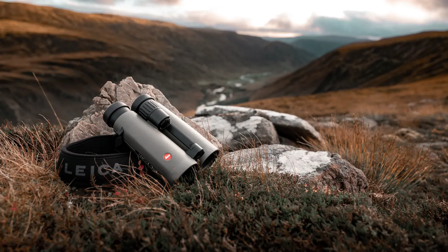 Leica-binoculars-Noctivid-8x42-lying-on-a-stone-in-the-Scottish-Highlands