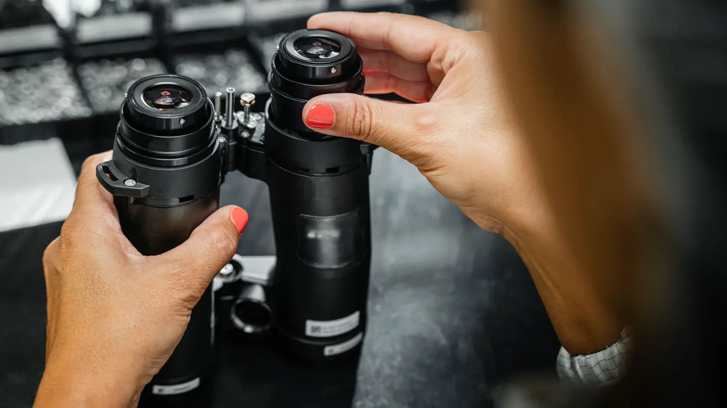 A worker making parts for the Leica binoculars