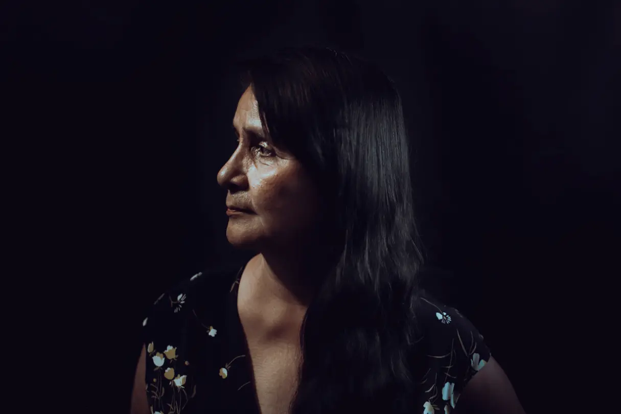 Woman in front of a black background