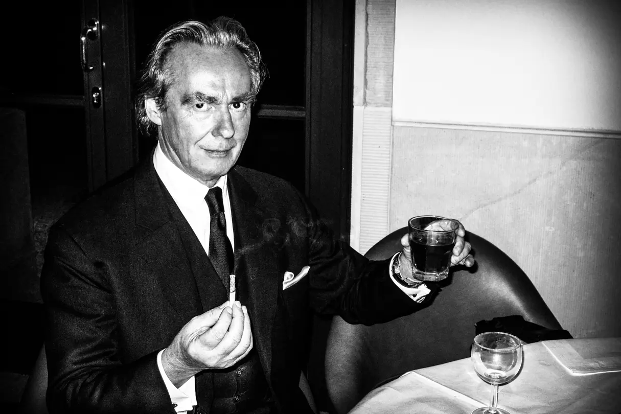 Man with drink in one hand