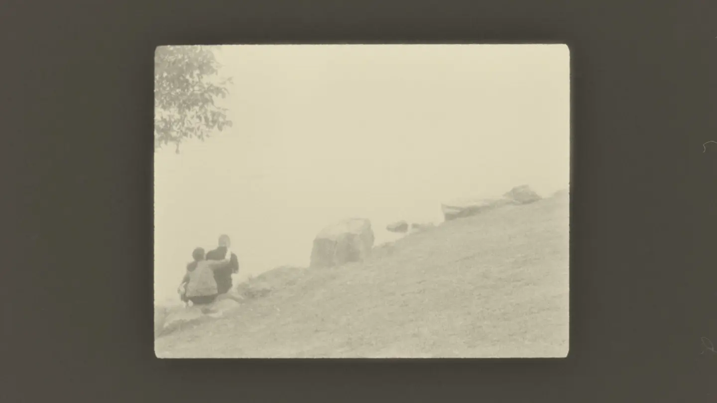 couple sitting hugging on large stones