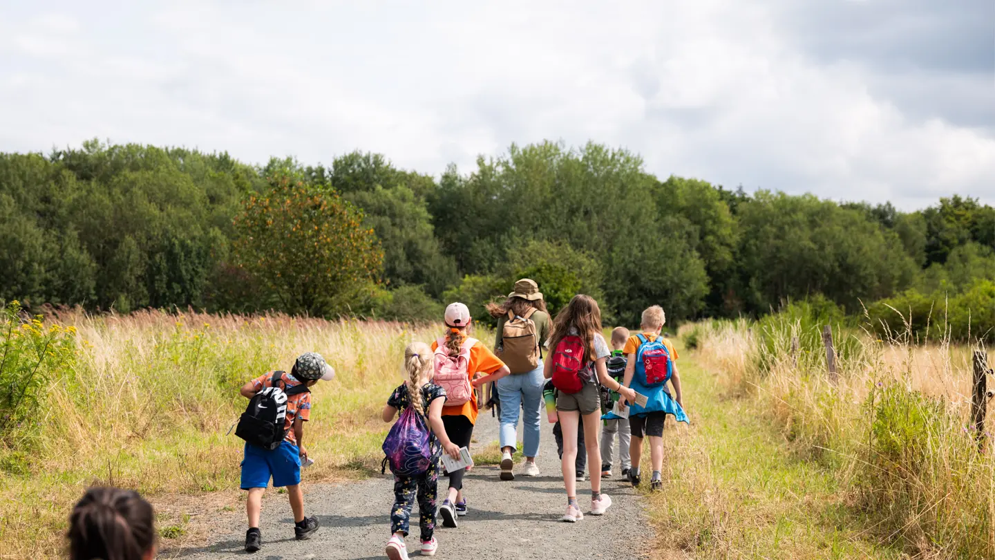 Group of children with backpacks hiking